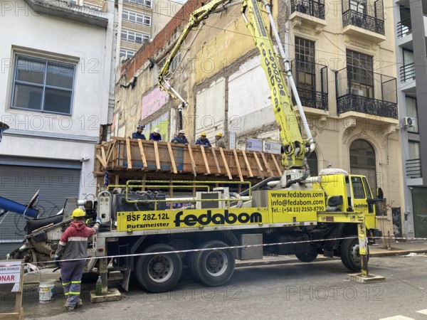 Construction workers waiting for the concrete, the Putzmeister concrete pump is ready, seen in Buenos Aires, Argentina