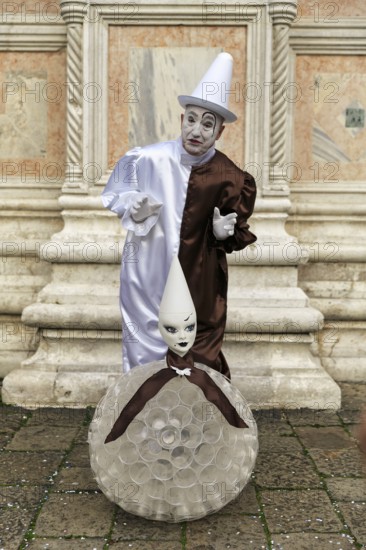 Pierrot, white painted face, conical hat, white clown, figure of the Commedia dell'arte, melancholic facial expression and gestures, Carnival in Venice, Italy