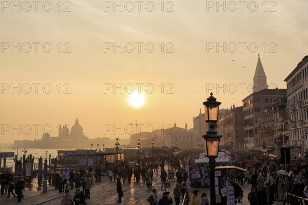 Crowd, Boat dock at St Mark's Square, St Mark's Basilica, Church on the horizon, Sunset in winter, Backlight, Venice, Italy