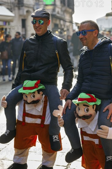 Funny costumes, two men with sunglasses, riding piggyback, illusion, equestrian costume, carnival in Venice, Italy