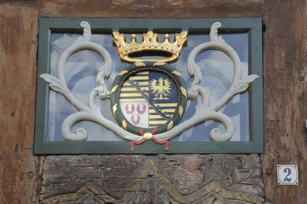 Coat of arms and golden crown at the entrance to the Eulenspiegel Museum, house number, 2, Am Markt, Mölln, Schleswig-Holstein, Germany
