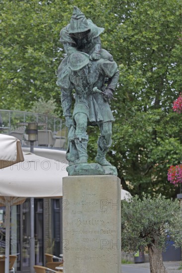 Sculpture Huckup monument by Carl Röder 1905, carrying figures on the back, modern art, bronze sculpture, loaded, transport, piggyback, carrying, shoulder, back, pointed cap, city history, legend, Hildesheim, Lower Saxony, Germany