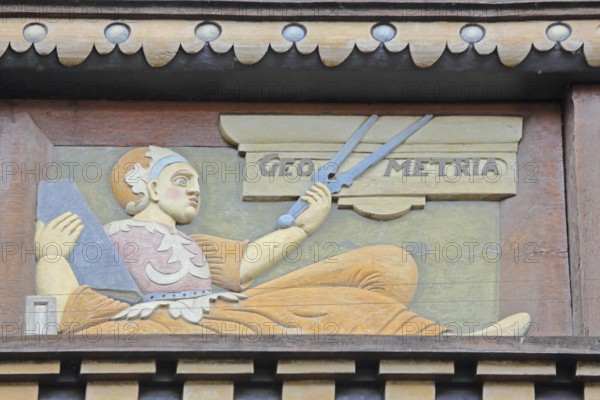 Allegorical woodcarving with figure for geometry with compass, geometric, measured, measurement, surveying, mathematics, Renaissance, allegory, symbol, craftsmanship, art, historical painting, Latin inscription, detail, decoration, Wedekindhaus, savings bank, market square, Hildesheim, Lower Saxony, Germany