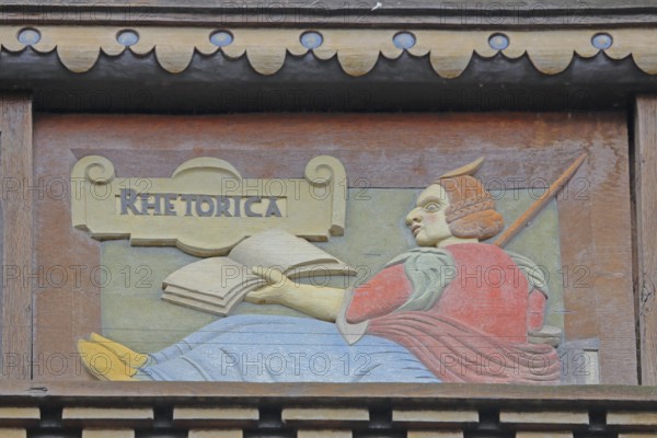Allegorical woodcarving with figure on rhetoric, speaking, book, Renaissance, allegory, symbol, craftsmanship, art, historical painting, Latin inscription, detail, decoration, Wedekindhaus, Sparkasse, market square, Hildesheim, Lower Saxony, Germany