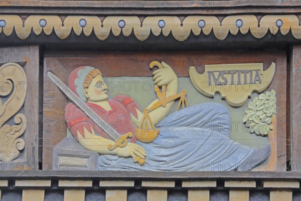 Allegorical woodcarving with figure of Justitia with beam balance and sword, justice, law, Renaissance, allegory, symbol, handicraft, art, historical painting, Latin inscription, detail, decoration, Wedekindhaus, savings bank, market square, Hildesheim, Lower Saxony, Germany