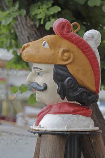 Colourful Swedish head as a landmark, historic wooden head with face and four eyes, tree house, Old Harbour, Wismar, Mecklenburg-Western Pomerania, Germany