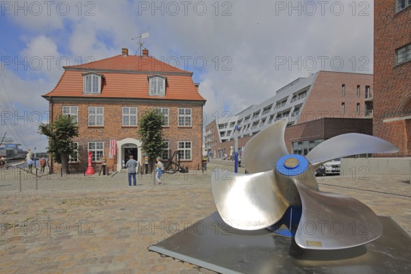 Baroque tree house with ship's propeller, brick building, tourists, Old Harbour, Wismar, Mecklenburg-Western Pomerania, Germany