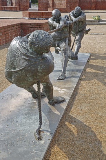 Tug-of-war by Karl-Henning Seemann 1987, bronze sculpture, modern art, tug-of-war, rope, sport, fighting, pulling, strength, St Mary's Church Tower, Wismar, Mecklenburg-Western Pomerania, Germany