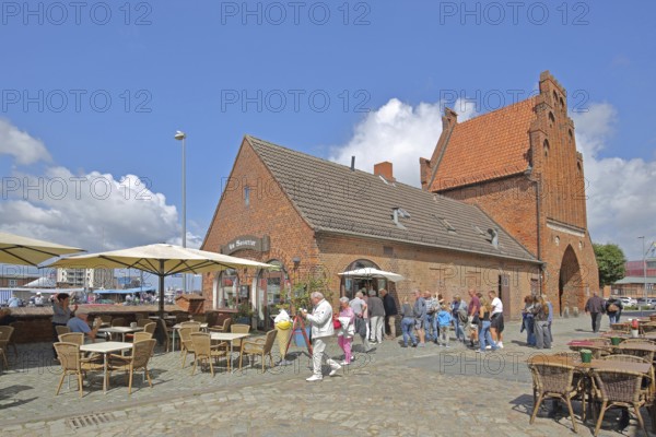 Historic water gate as part of the former town fortifications, street pub, restaurant, ice cream parlour, pedestrian, brick gothic, brick building, town gate, stepped gable, stepped gable, stepped gable, Wismar, Mecklenburg-Western Pomerania, Germany