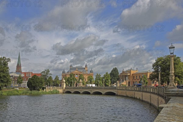 View over the castle lake to the castle bridge with tower of the cathedral, state theatre and state museum, waterfront promenade, cityscape, Schwerin, Mecklenburg-Western Pomerania, Germany