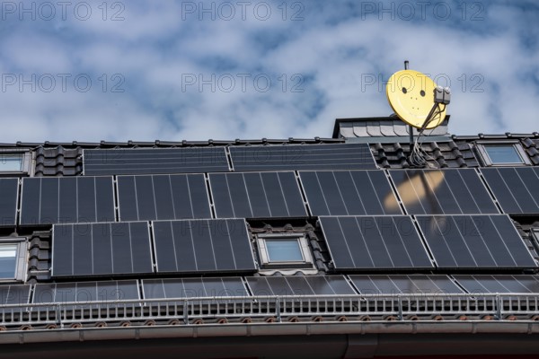 Residential building with photovoltaic modules on the roof, North Rhine-Westphalia, Germany
