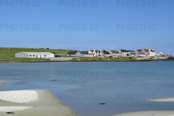 Small coastal village with houses on the waterfront under a blue sky, Pierowal, Westray, Orkney Islands, Scotland, Great Britain