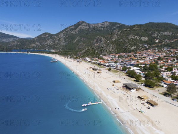 Aerial view of a long sandy beach with neighbouring town and mountainous background, aerial view, Fethiye, Mugla, Mugla, Aegean Sea, Turkey