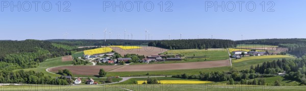 Panorama of a rural landscape with fields and wind turbines under a blue sky, near Böhmenkirch, Swabian Alb, Baden-Württemberg, Germany