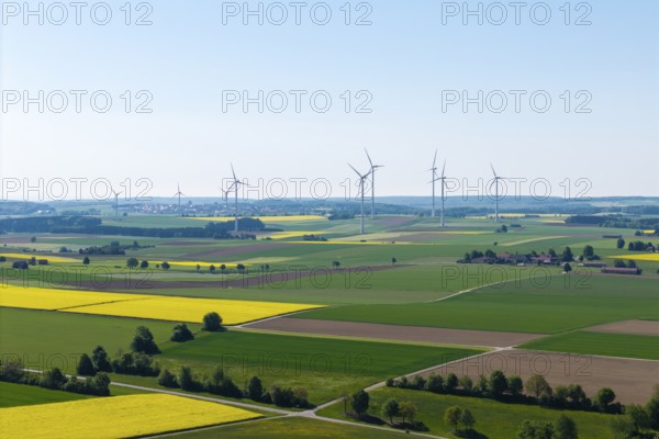 Flat landscape with wind turbines and yellow fields under a clear sky, near Böhmenkirch, Swabian Alb, Baden-Württemberg, Germany