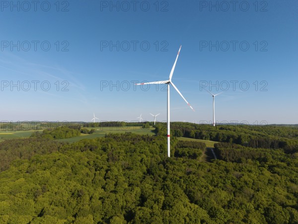 Wind turbine landscape in the middle of a forest under a blue sky, near Westerheim, Swabian Alb, Baden-Württemberg, Germany