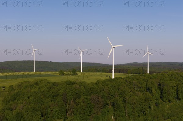 Green landscape with wind turbines, surrounded by forest, near Westerheim, Swabian Alb, Baden-Württemberg, Germany