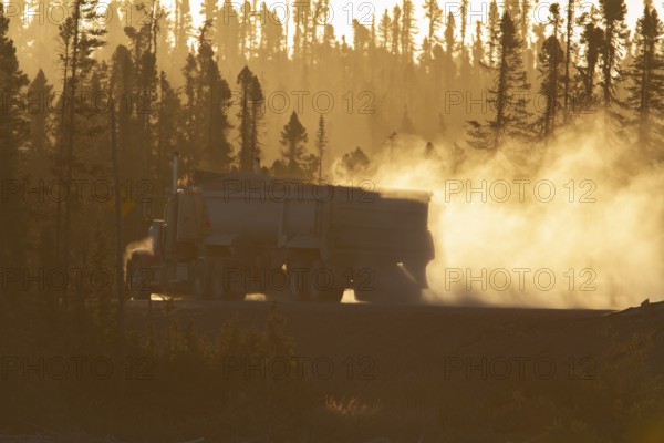 Transport truck driving on a dusty forest track, Province of Quebec, Canada, North America