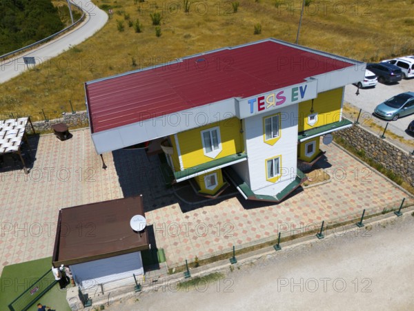 Building with car park against a rural backdrop, aerial view, Ters Ev, upside down house, Safranbolu, Karabük province, Central Anatolia, Turkey