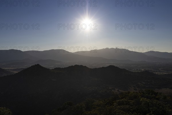 The sun rises over the mountainous landscape of Sardinia, Monte Nai, Costa Rei, Sardinia, Italy