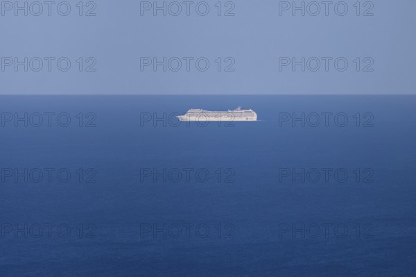 A cruise ship passes near the Costa Rei on the Mediterranean Sea near Sardinia, Monte Nai, Costa Rei, Sardinia, Italy