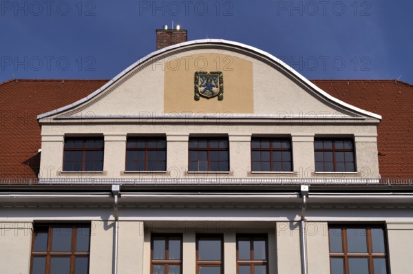 Blaumännle, heraldic figure, town coat of arms, logo, front of the primary school, Blaubeuren, Baden-Württemberg, Germany