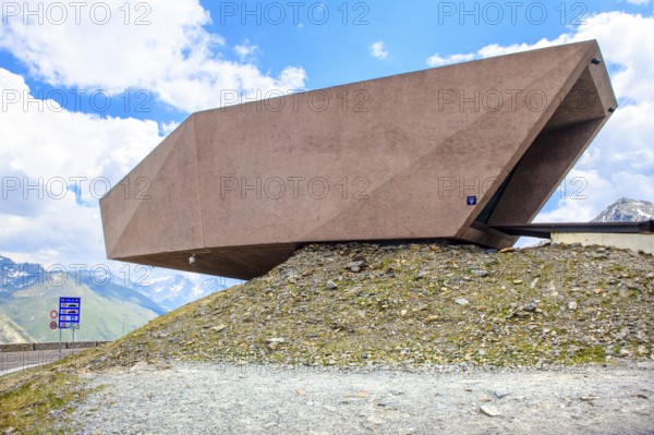 Timmelsjoch Pass Museum of reddish-coloured concrete with entrance on Austrian territory on the right protruding over the national border on Italian territory on the left, symbol of the bond between Tyrol and South Tyrol, Timmelsjoch, Tyrol, Austria, Passo del Rombo, South Tyrol, Italy