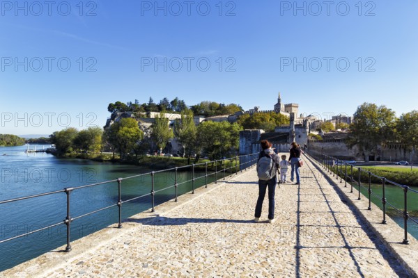 Strollers on the Pont Saint Benezet, Pont d'Avignon, Avignon Cathedral, Avignon, Vaucluse, France