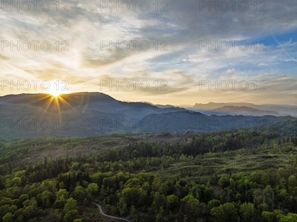 Sunset over Mountains and Coniston Water from drone, Lake District National Park, Cumbria, England, United Kingdom