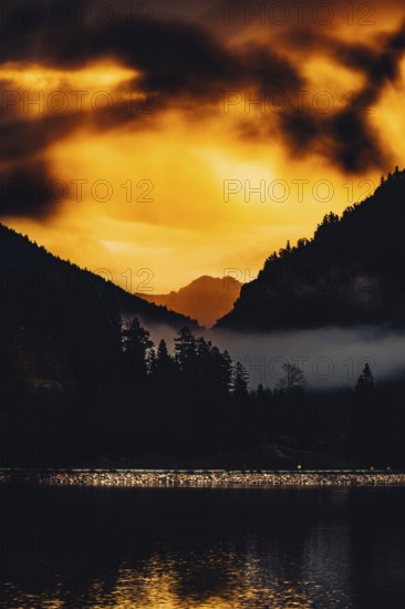 Surreal light atmosphere at sunrise at Plansee, Tyrol, in the Alps in Austria