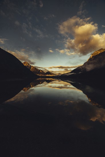 Sunrise with reflections in Lake Heiterwanger See in Tyrol in the Alps in Austria