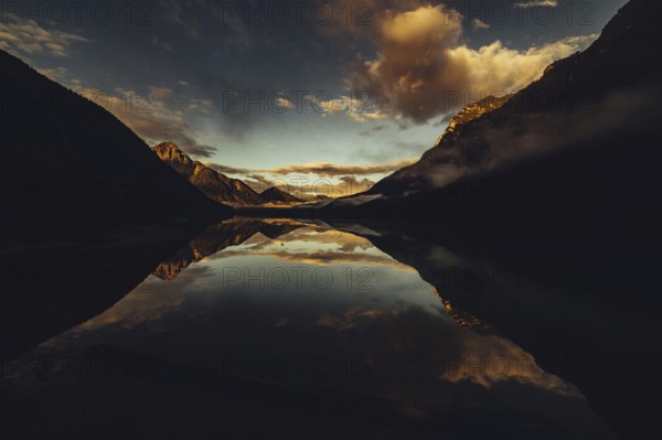 Sunrise with reflections in Lake Heiterwanger See in Tyrol in the Alps in Austria