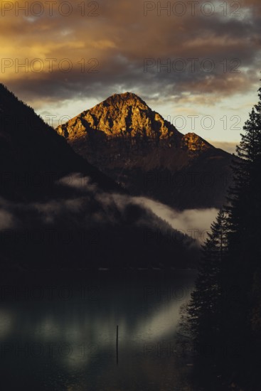 Sunrise with reflections and alpenglow in Lake Heiterwanger See in Tyrol in the Alps in Austria