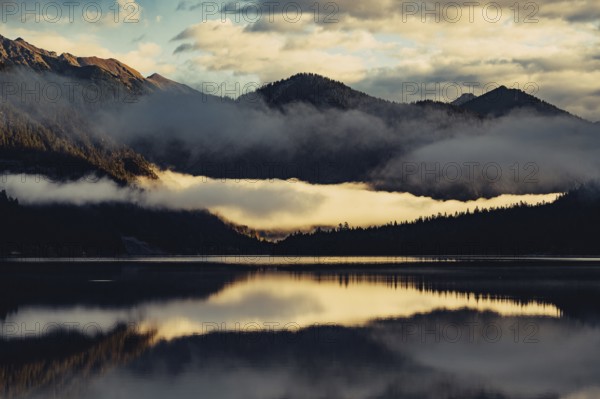 Sunrise with reflections and alpenglow in Lake Heiterwanger See in Tyrol in the Alps in Austria