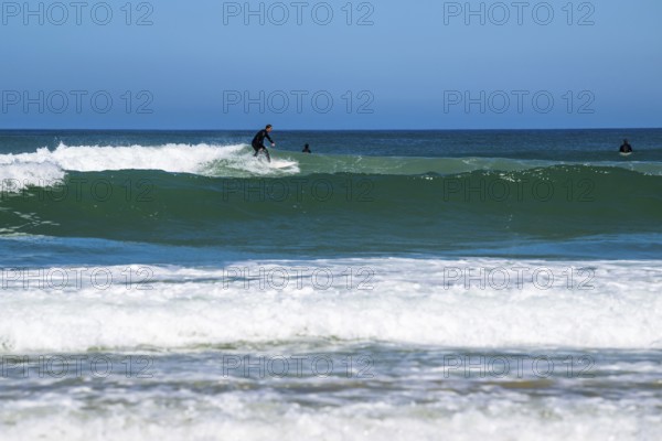 Surfer riding a wave on Contis beach, Saint Julien en Born, Saint-Julien-en-Born, Landes, France