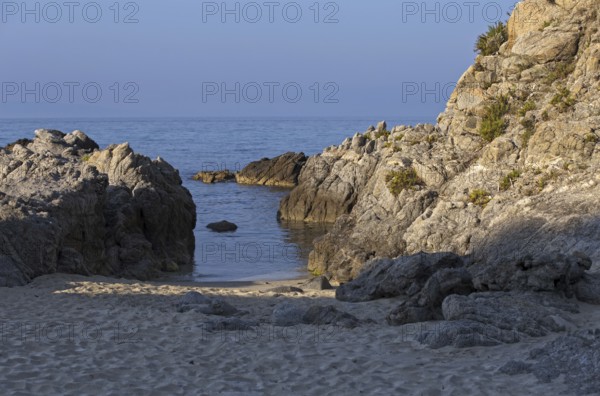 Small bay with calm water, surrounded by rocks and sandy beach, Ricadi, Capo Vaticano