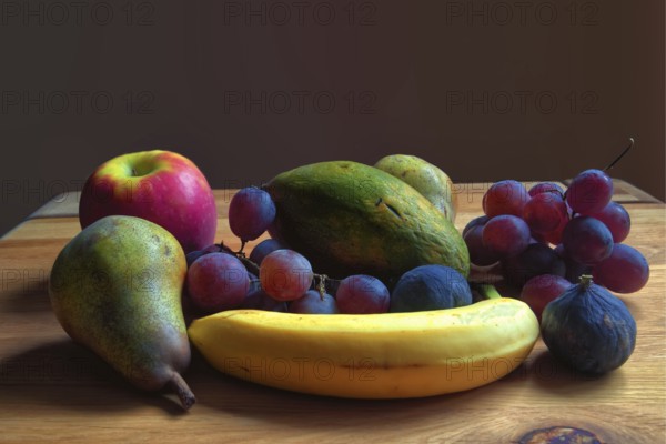 Fresh fruit arrangement of pears, grapes and bananas on a wooden table, Willich, North Rhine-Westphalia