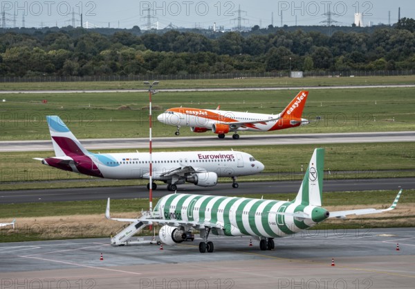 Düsseldorf Airport, Condor Airbus A321-200, aircraft on the apron, Eurowings Airbus on the taxiway for take-off, EasyJet Airbus A320-200 on take-off, North Rhine-Westphalia, Germany