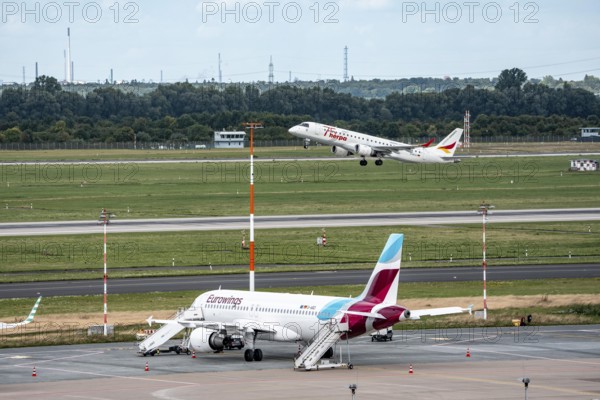 Düsseldorf Airport, Eurowings Airbus aircraft on the apron, German Airways Embraer ERJ-190 taking off, Special Edition, Herpa miniature models 75 Years, North Rhine-Westphalia, Germany