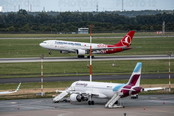 Düsseldorf Airport, Eurowings Airbus aircraft on the apron, Turkish Airlines Airbus A330-200 taking off, North Rhine-Westphalia, Germany