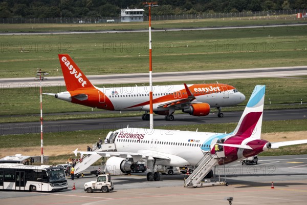 Düsseldorf Airport, Eurowings Airbus aircraft on the apron, EasyJet Airbus A320-200 taxiing for take-off, North Rhine-Westphalia, Germany