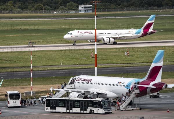 Düsseldorf Airport, Eurowings aircraft taking off, Eurowings Airbus on the apron, passengers disembarking, North Rhine-Westphalia, Germany