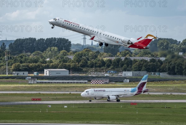 Düsseldorf Airport, Iberia Regional Mitsubishi CRJ-1000, Air Nostrum, on take-off, Eurowings Airbus aircraft after landing, North Rhine-Westphalia, Germany