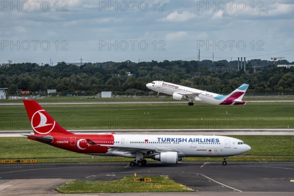 Düsseldorf Airport, Eurowings Airbus on take-off, Turkish Airlines Airbus A330-200 on the taxiway for take-off, North Rhine-Westphalia, Germany