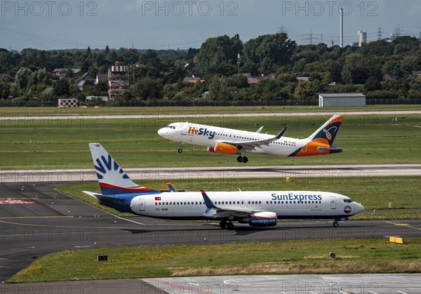 Düsseldorf Airport, Sunexpress Boeing 737 aircraft on the apron, HiSky Europe Airbus A320-200 taking off, North Rhine-Westphalia, Germany