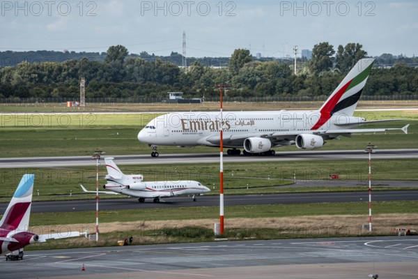 Düsseldorf Airport, Emirates Airbus A380-800, on take-off, Dassault Falcon 7X, of the American company S. C. Johnson & Son on the way to take-off, North Rhine-Westphalia, Germany