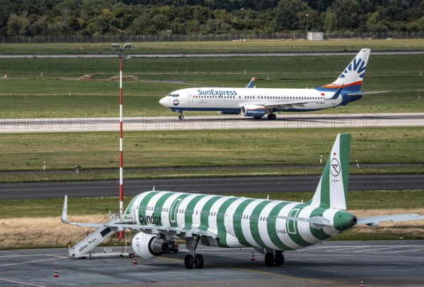 Düsseldorf Airport, Condor Airbus A321-200, aircraft on the apron, SunExpress Boeing 737 taking off, North Rhine-Westphalia, Germany