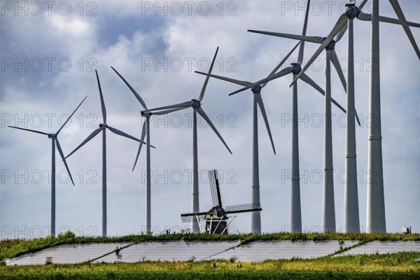 Westereems and Growind wind farms, over 80 wind turbines in total, at the seaport of Eemshaven, province of Groningen, in the north-west of the Netherlands, historic Goliath windmill from 1897, solar farm on sea dike, Slaperdijk, a good 5 kilometres long