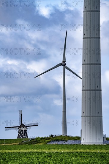 Westereems and Growind wind farms, over 80 wind turbines in total, at the Eemshaven seaport, province of Groningen, in the north-west of the Netherlands, historic Goliath windmill from 1897