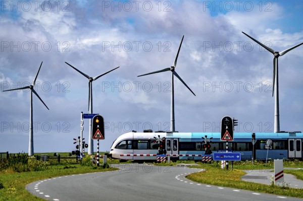 Westereems and Growind wind farms, over 80 wind turbines in total, at Eemshaven seaport, province of Groningen, in the north-west of the Netherlands, train connection to Eemshaven seaport, in the Ems estuary, the British transport company Arriva operates a train connection from Groningen Centraal station